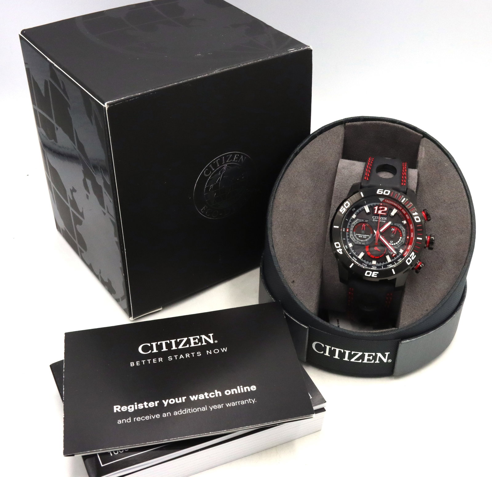 Citizen Eco drive watch: Citizen Eco drive watch with black and red rubber strap. Comes with inner and outer box and booklet. The total weight of the watch is 96.4 grams.