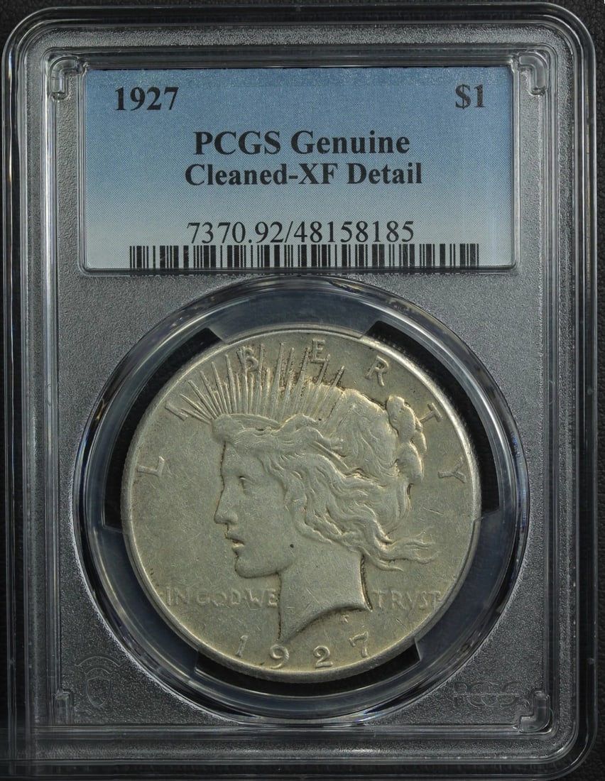 1927 Peace Silver Dollar PCGS Genuine Cleaned XF Detail: 1927 Peace Silver Dollar certified by PCGS as Genuine Cleaned with XF Detail. This classic American silver dollar features the iconic Peace Dollar design by Anthony de Francisci, struck during the pos