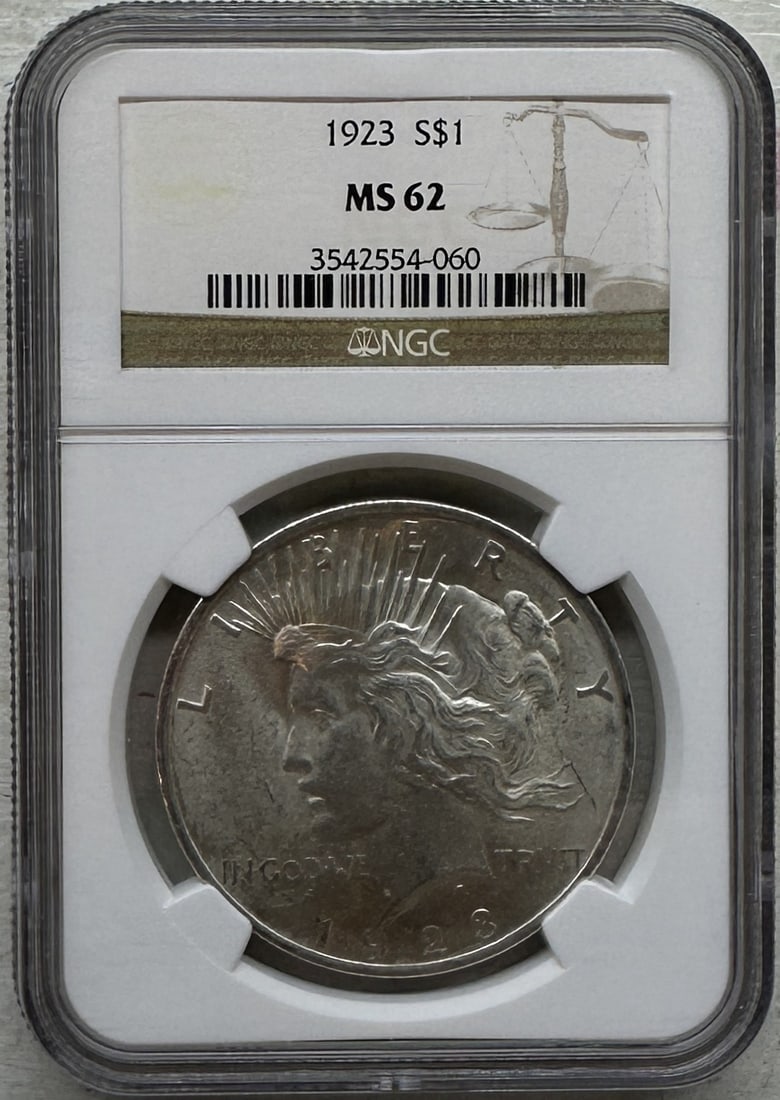 1923 Peace Silver Dollar NGC MS62 Certified: 1923 Peace Silver Dollar, certified MS62 by NGC. Own a classic piece of American numismatic history with this Struck in 90% silver, the Peace Dollar was introduced to commemorate the restoration of pe