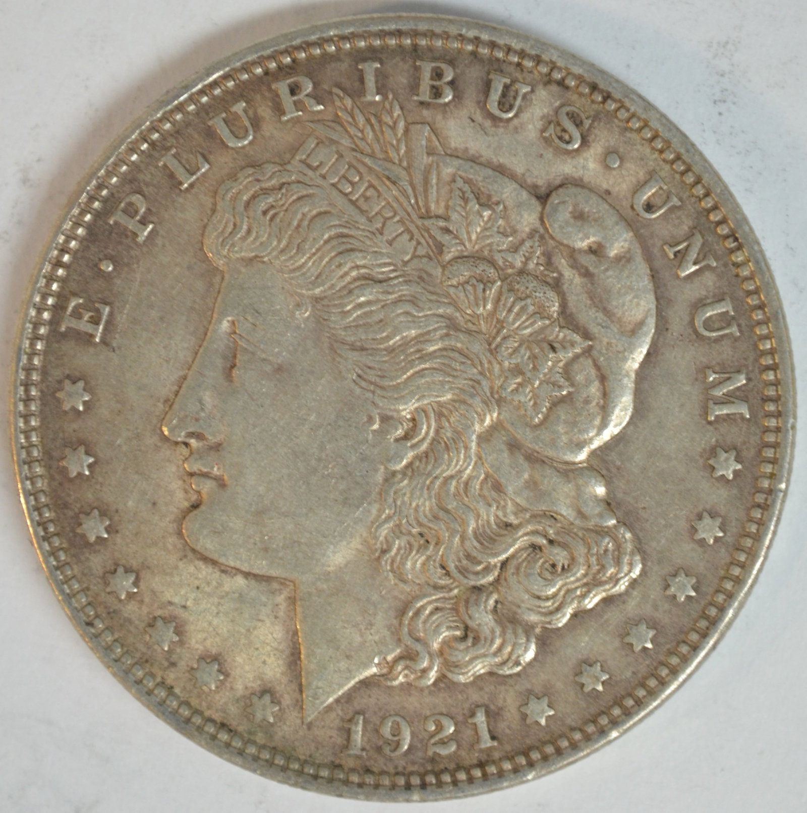 1921 Morgan Silver Dollar Philadelphia Mint Better Circulated Example 90% Silver: 1921 Morgan Silver Dollar, the final year of the iconic Morgan Dollar series before the introduction of the Peace Dollar later that same year. Struck in 90% silver and 10% copper, this historic coin r