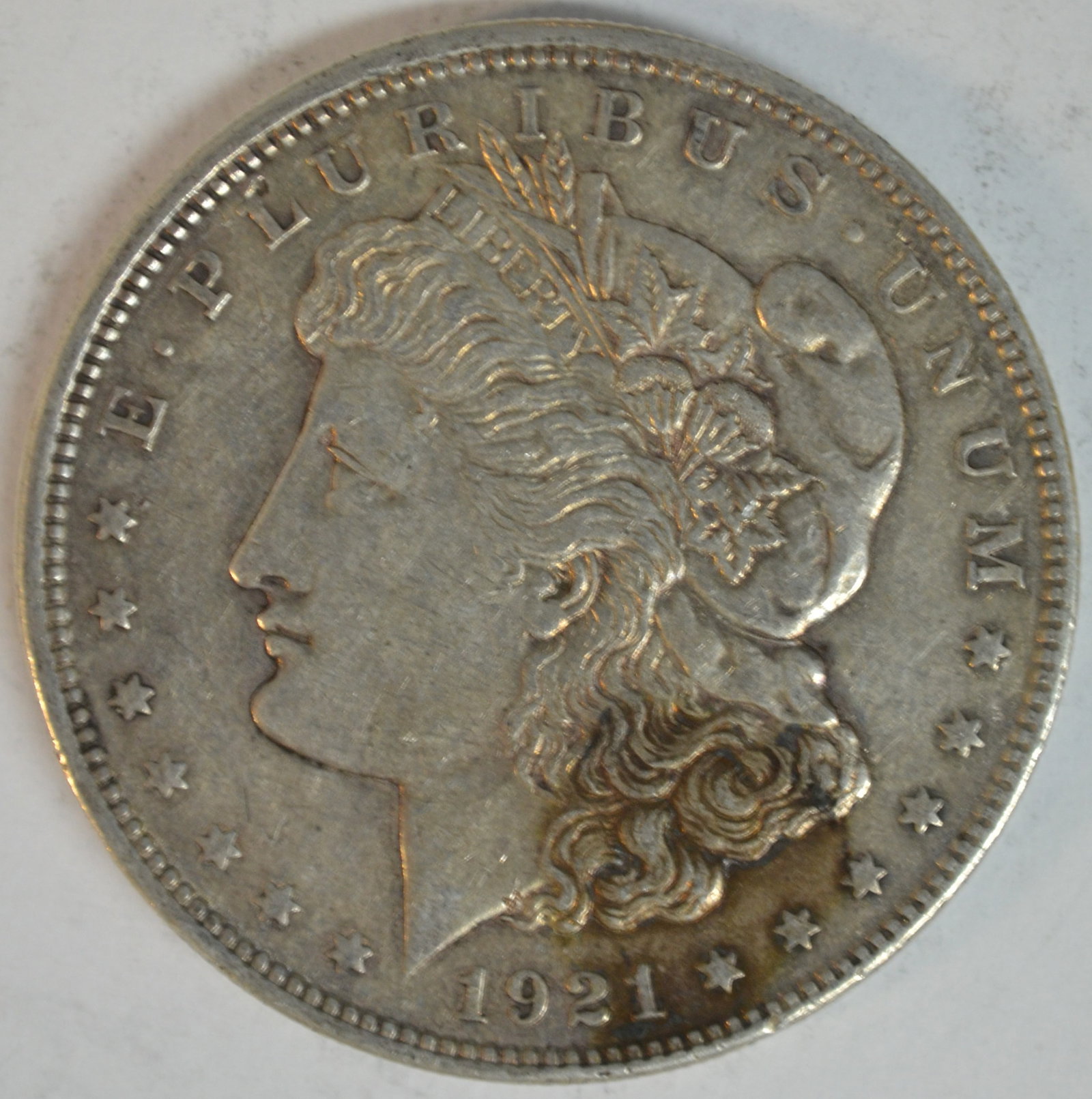 1921 Morgan Silver Dollar Better Detail with Original Silver Surfaces U.S. $1 Coin: 1921 Morgan Silver Dollar, the final year of the historic Morgan Dollar series before the introduction of the Peace Dollar later that same year. Struck in 90% silver and 10% copper, Morgan Dollars rem