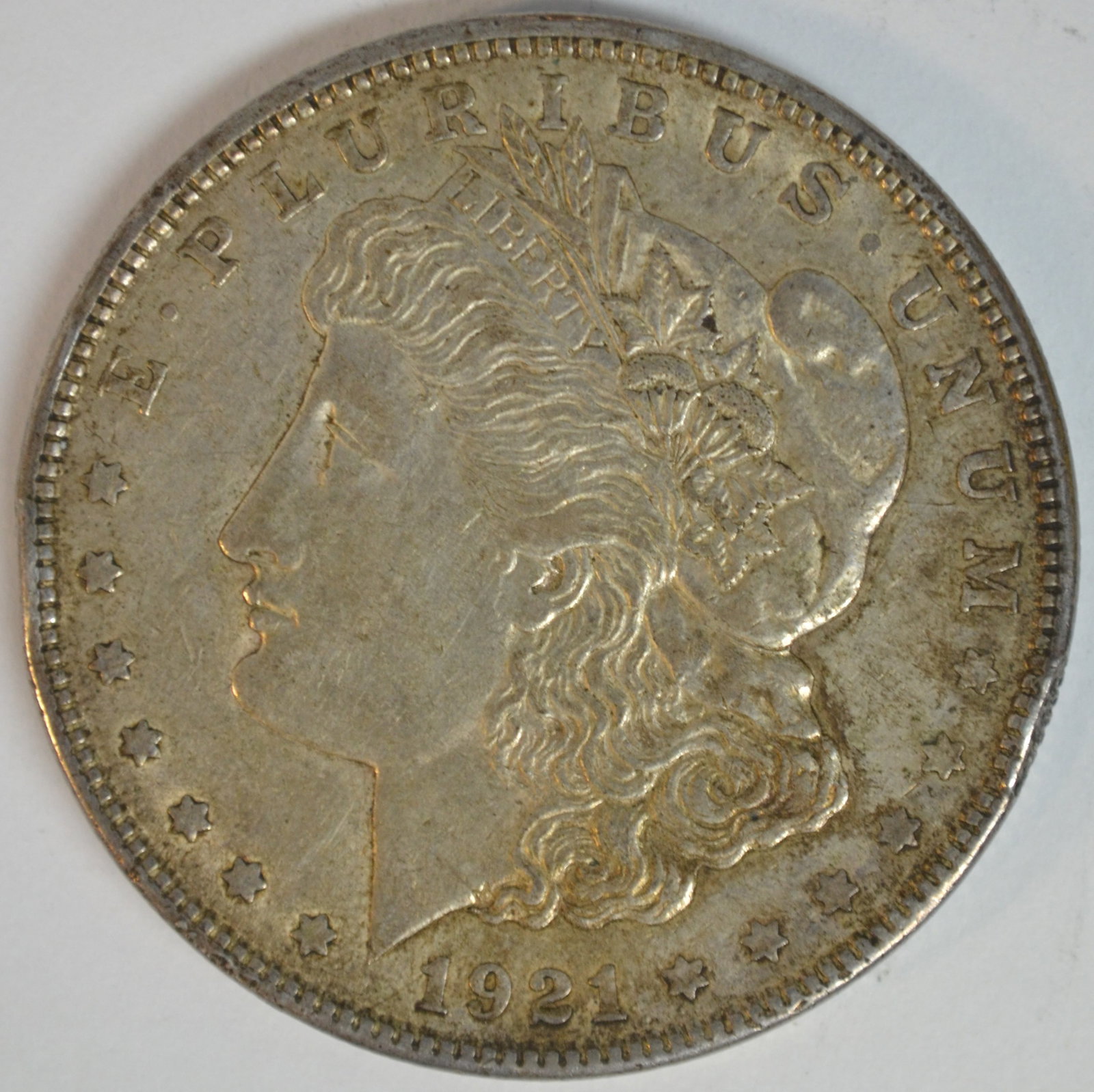 1921 Morgan Silver Dollar Philadelphia Mint Better Circulated Example: 1921 Morgan Silver Dollar, the final year of issue for the historic Morgan Dollar series. Struck in 90% silver at the Philadelphia Mint (no mint mark), this coin features the classic George T. Morgan 