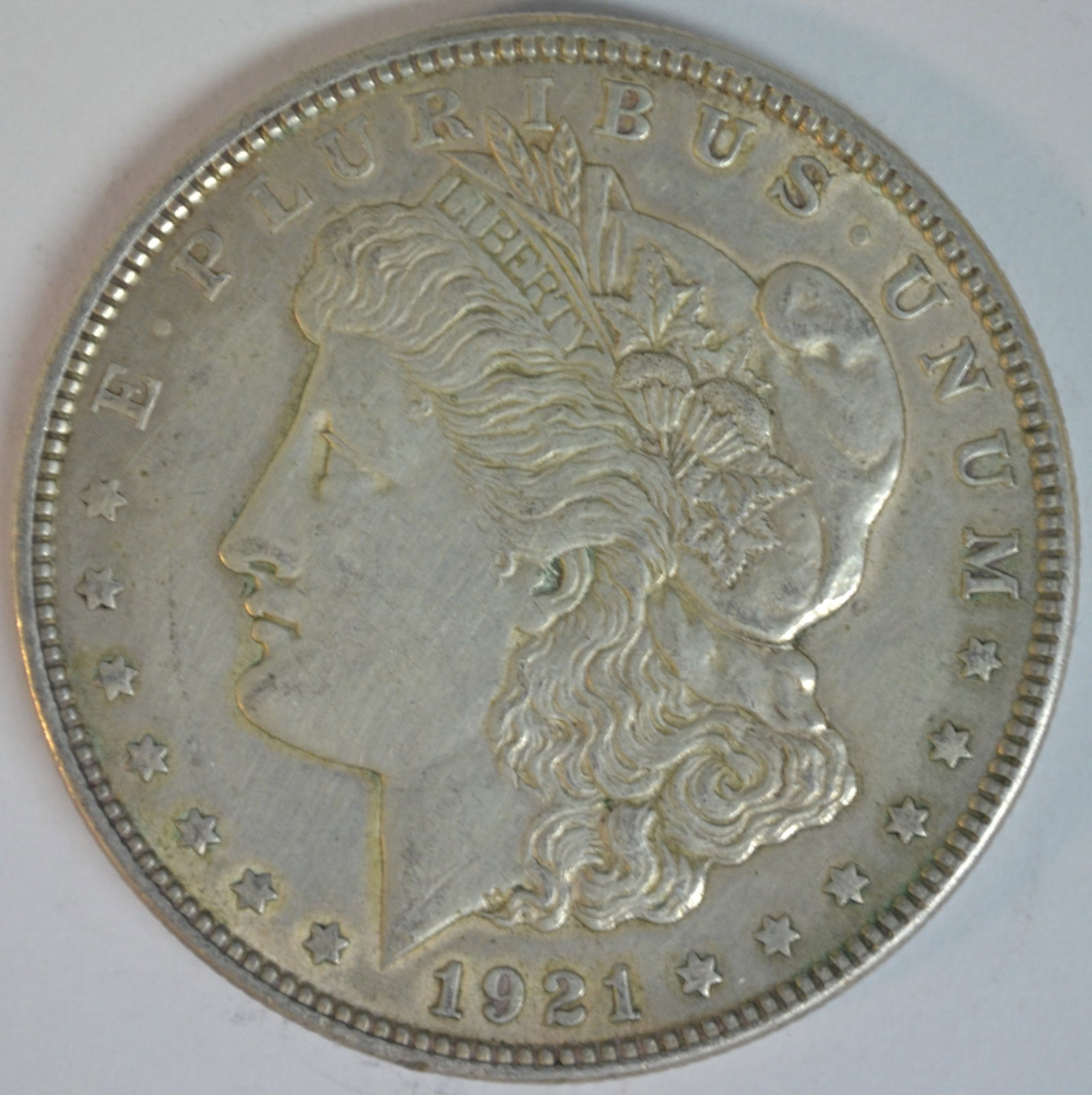 1921 Morgan Silver Dollar Philadelphia Mint Better Circulated Example: 1921 Morgan Silver Dollar, the final year of issue for the iconic Morgan Dollar series. Struck at the Philadelphia Mint (no mint mark), this coin features the classic portrait of Liberty on the
