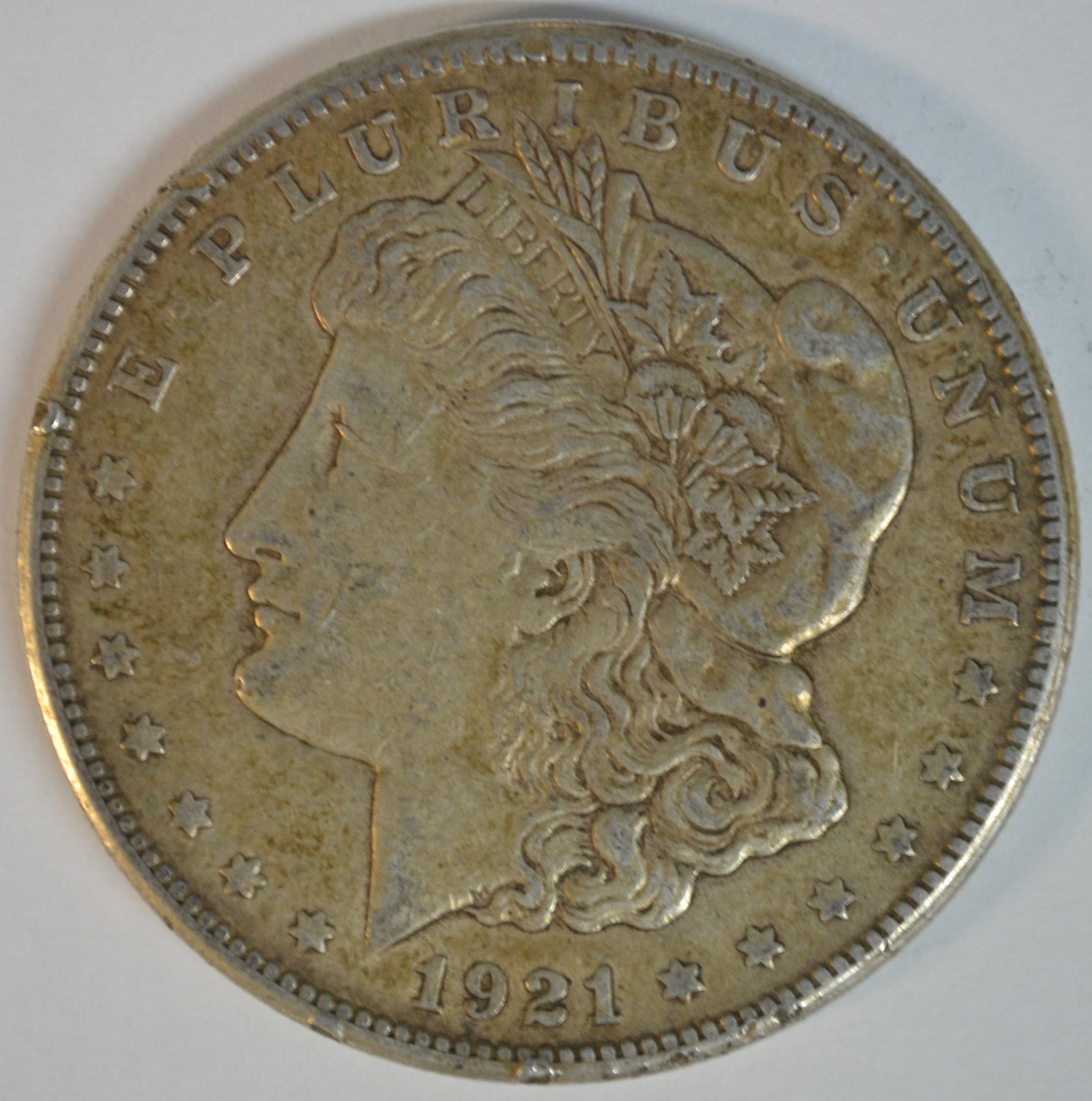 1921-S Morgan Silver Dollar San Francisco Mint Circulated Silver Dollar: 1921-S Morgan Silver Dollar, struck at the San Francisco Mint during the final year of Morgan Dollar production. The "S" mintmark is visible beneath the wreath on the reverse. Very Fine (VF-20 to