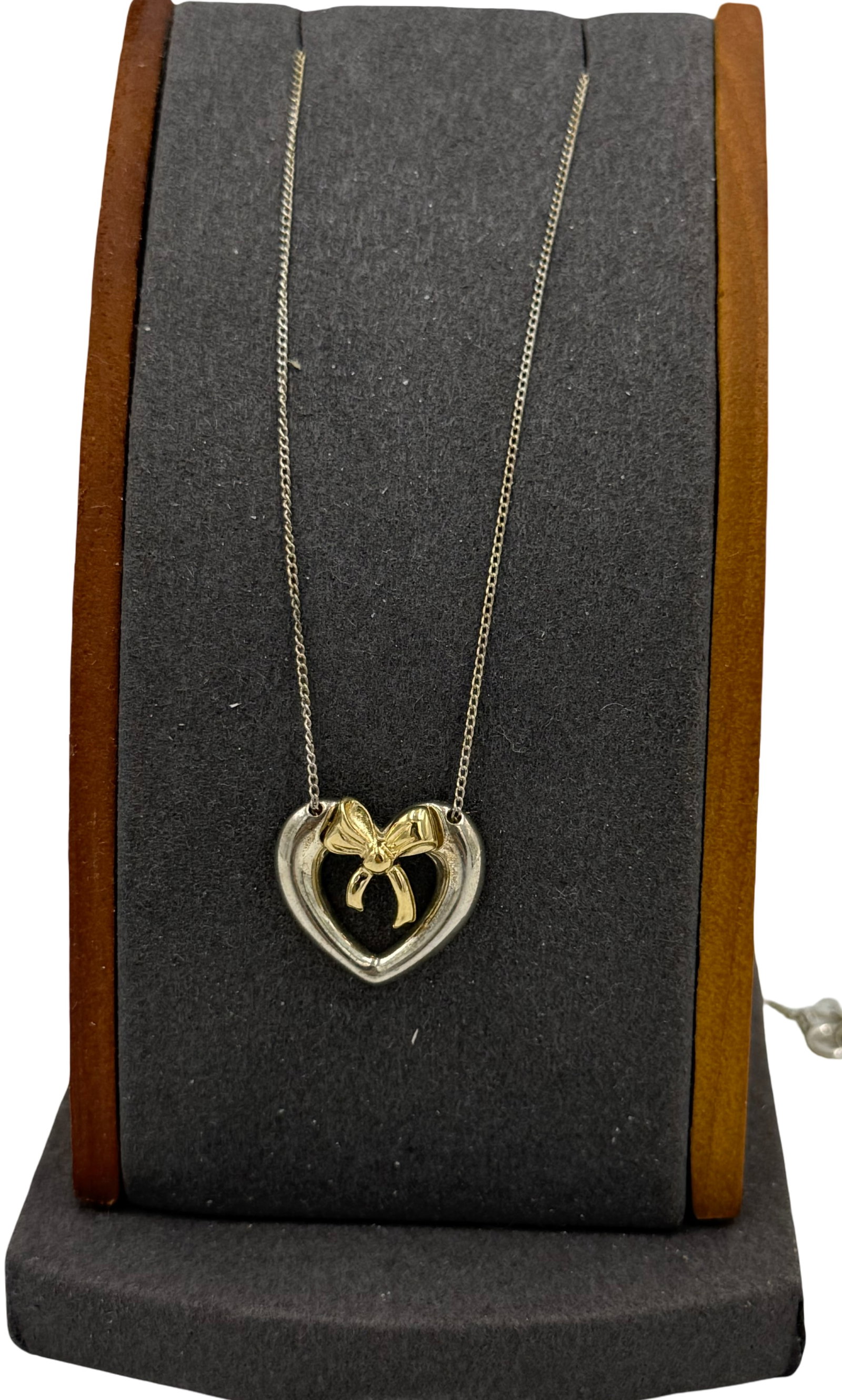 Tiffany & Co Bow tie heart pendant on chain: Tiffany & Co Bow tie heart pendant on 18-inch box chain necklace in 925 sterling silver. The total weight of the necklace is 4.70 grams.