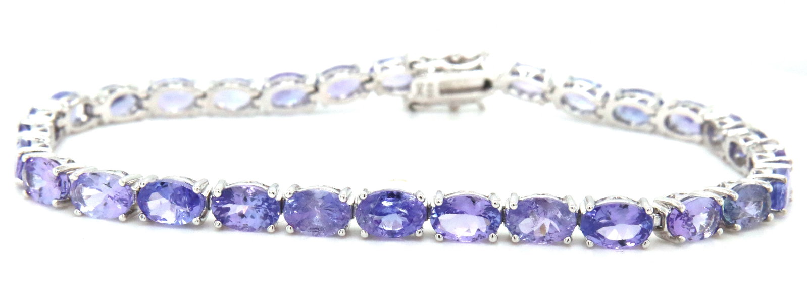 925 sterling silver oval cut tanzanite tennis bracelet: 925 sterling silver approximate 13.80ctw 29 oval cut tanzanite 7.5-inch tennis bracelet. The total weight of the bracelet is 9.49 grams.