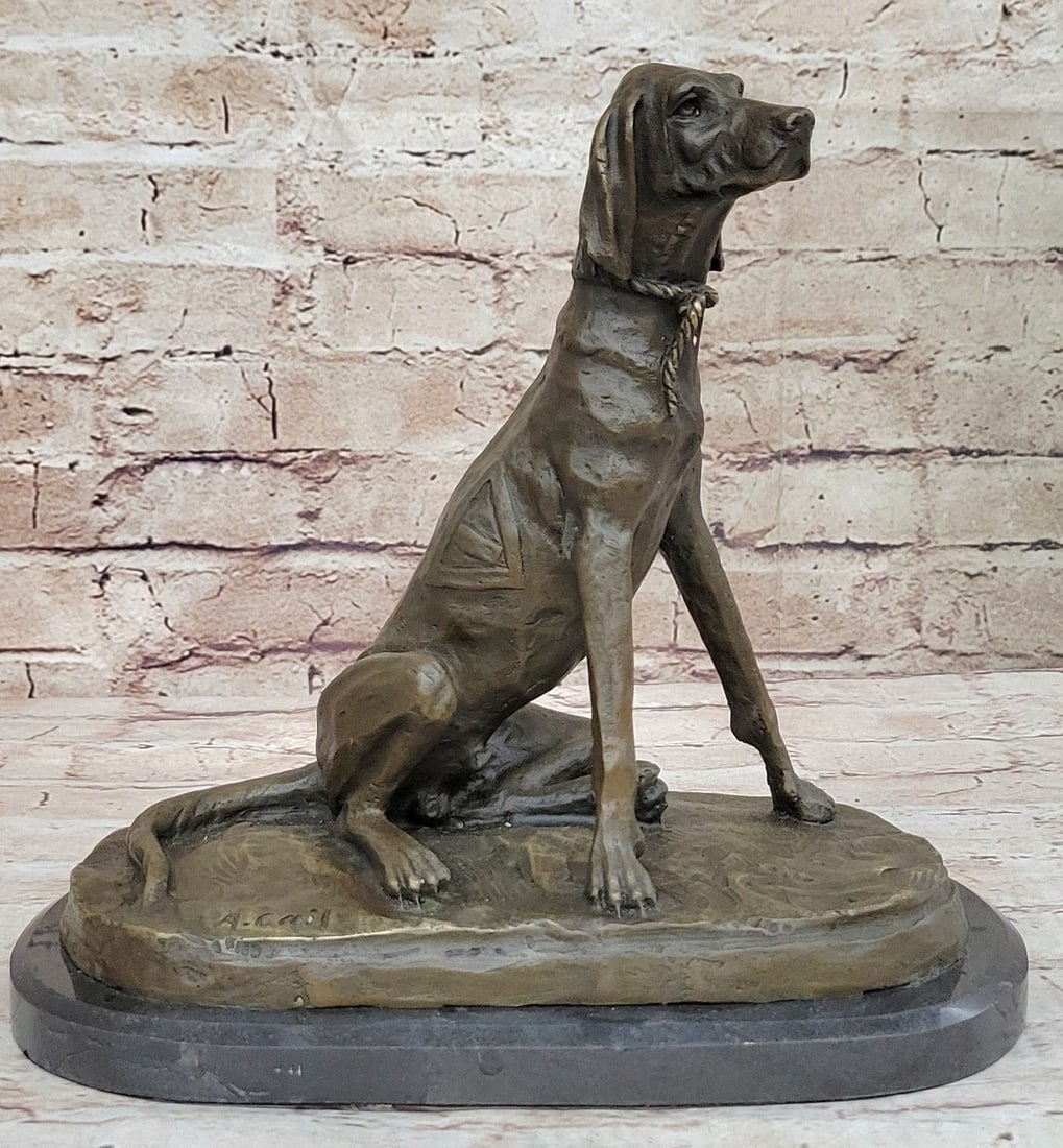 Foxhound Dog Bronze Sculpture: This golden brown hound rests lazily on its back legs. Like most hounds of its time, this pup is branded with a triangle icon along his rib cage. A braided rope acts as a collar around his neck. He ha