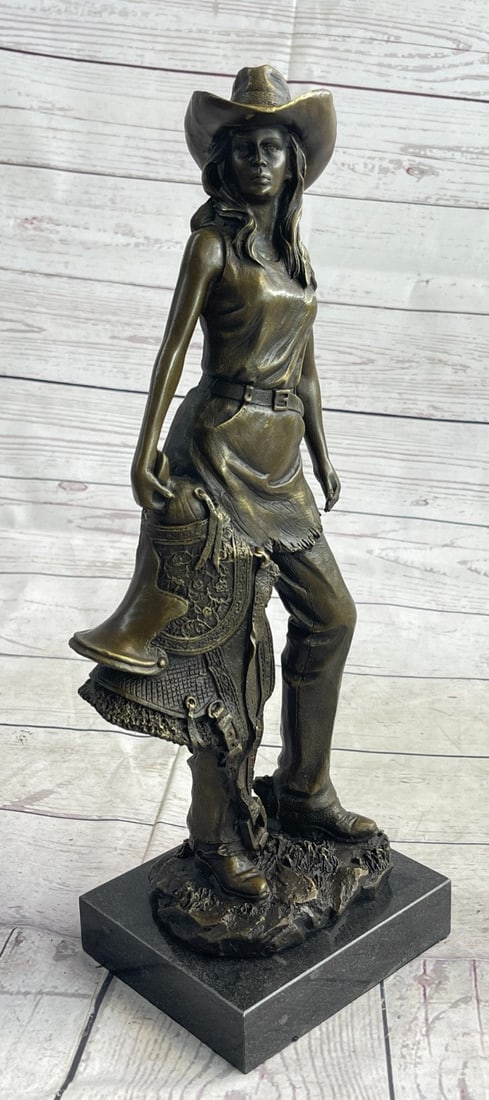 Hot Cast Cowgirl with Saddle Bronze Sculpture: Standing tall and proud, this western rose proves that the range is not just for the boys! Expertly cast in real bronze, this lasso-wielding lady has been beautifully rendered in pure weathered bronze