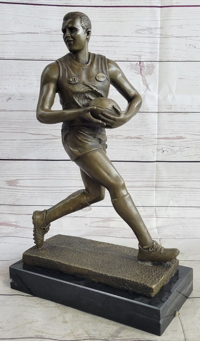 Hot Cast Rugged Rugby Player Bronze Sculpture Marble Base Statue Figure: A muscular Rugby player runs for the end field, trying to skip the yards and avoid being tackled. His powerful legs ache as he sprints and dodges. He Kicked the ball under his protectively. Every once