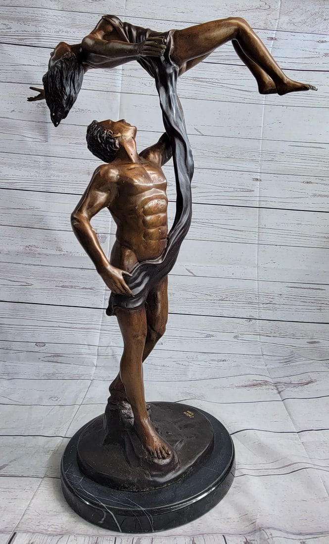 Poised Dancer Ballerina Bronze Sculpture: This lovely Sculpture of a man ballerina carrying his partner up high above him. The strength of this man is magnificent, he carries her with just one hand. A piece of clothing above their nude bodies