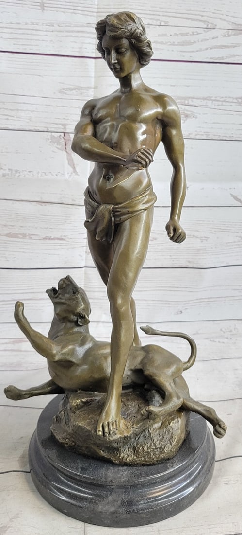 Nude Male Killing Lion Bronze Sculpture: Stabbed Leopards is shown giving his last snarl, blood is visible behind his left foreleg. Youth Confident but cautious has just removed the dagger. This piece won the first gold medal at the Paris