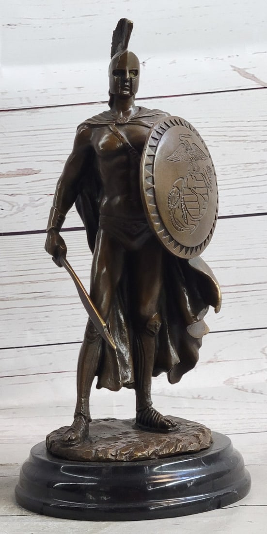 Greek Spartan Warrior Roman Bronze Sculpture: The Roman legion soldier stands nude, except for some regalia, looking to the horizon of a scarred battlefield. A top of his head he wears a galea, which is a soldier is helmet. A baldric strap