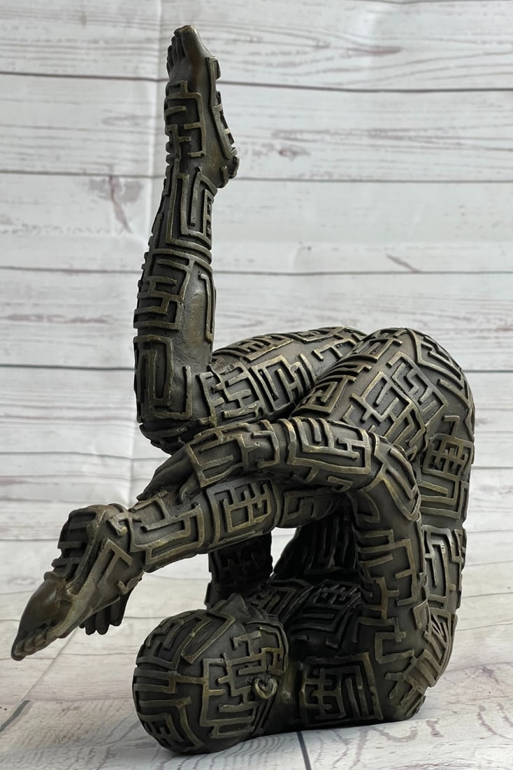 Yoga Exercise Bronze Sculpture: This abstract is a very odd and creative one, I guarantee you that you will have people talking about it. You can tell it is a figure of a man suspended in the air wearing an unusual design outfit,