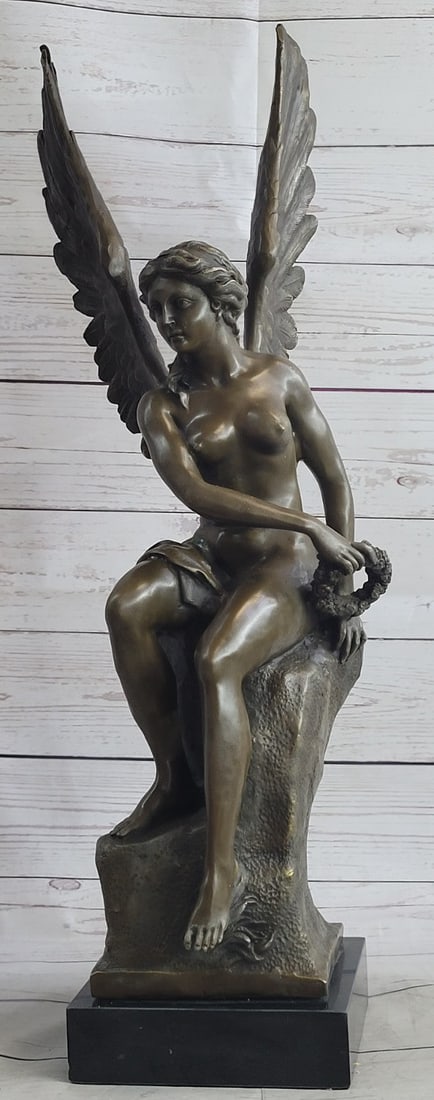 Nude Angel Bronze Sculpture: The beautiful angel sits upon her celestial throne having surveyed an earthly battle. She is captured in the likeness of ancient Roman/Hellenistic representations of winged angels. The exquisite detai