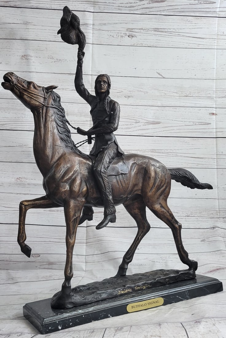 Indians Bronze Sculpture: The Buffalo Signal captures a Native American warrior who sits triumphantly atop his horse. He holds?his head high with defiance and triumph set in his intense eyes.?This two-toned brown patina sculpt