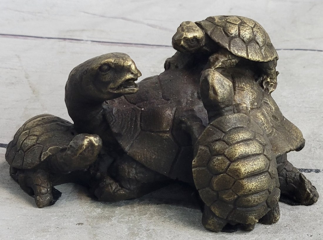 Turtle Family Bronze Figurine: The mother turtle can be seen here with three of her offspring along a marshy bed of a lake. Before they venture off into the wilderness to start their lives, they all crowd around, climbing about
