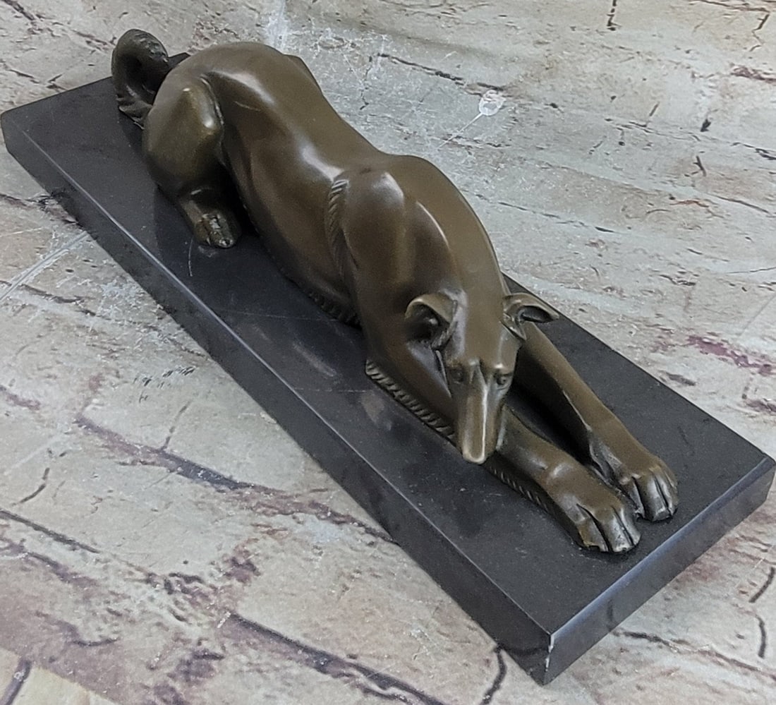 Loving Greyhound Dog Bronze Sculpture: This Patient And Loving Greyhound Dog Rests On The Ground. His Long, Lean Body Stretches Out And His Head Lays On His Front Leg. His Thick Tail Curls Up. The Strong And Skillful Animal Appears Calm