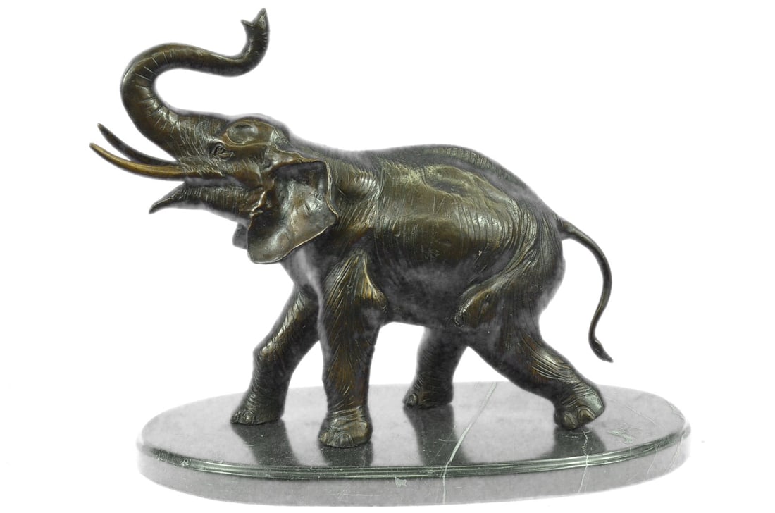 African Elephant Bronze Sculpture: He walks proudly through the dusty plains lifting his trunk up towards the sky while letting out a loud elephant trumpet to let his presence be known. The texturized skin of the elephant is amazing
