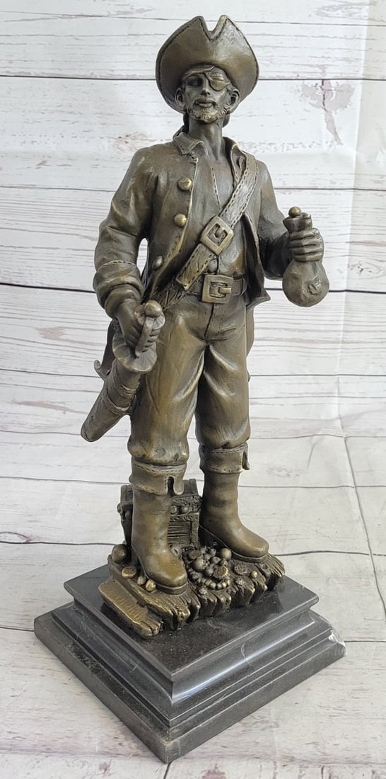 Pirate With Jewelry Chest and Sword Bronze Sculpture: This pirate stands with a sword ready in a swaggering pose, one hand on the sword hilt, one holding a bag of gold, and one foot resting on a coil of rope. A box full of jewelry is tucked next to him, 