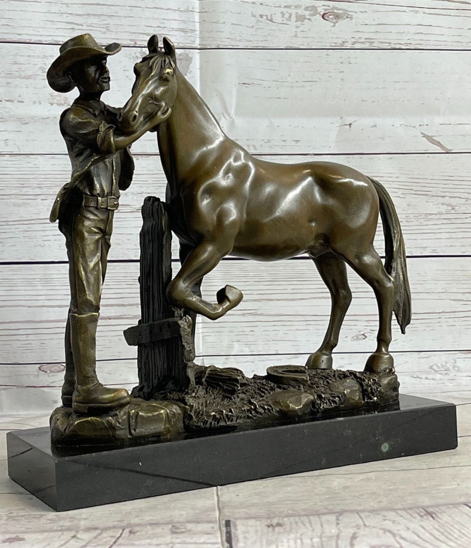 Hand Crafted Cowboy and his Trusted Horse Bronze Sculpture: The Trusted Companions in this sculpture, a cowboy and his horse, are eager and ready to ride the trail together. these bronze figures are standing on rocky soil with a Lucky Horseshoe. Cowboy has