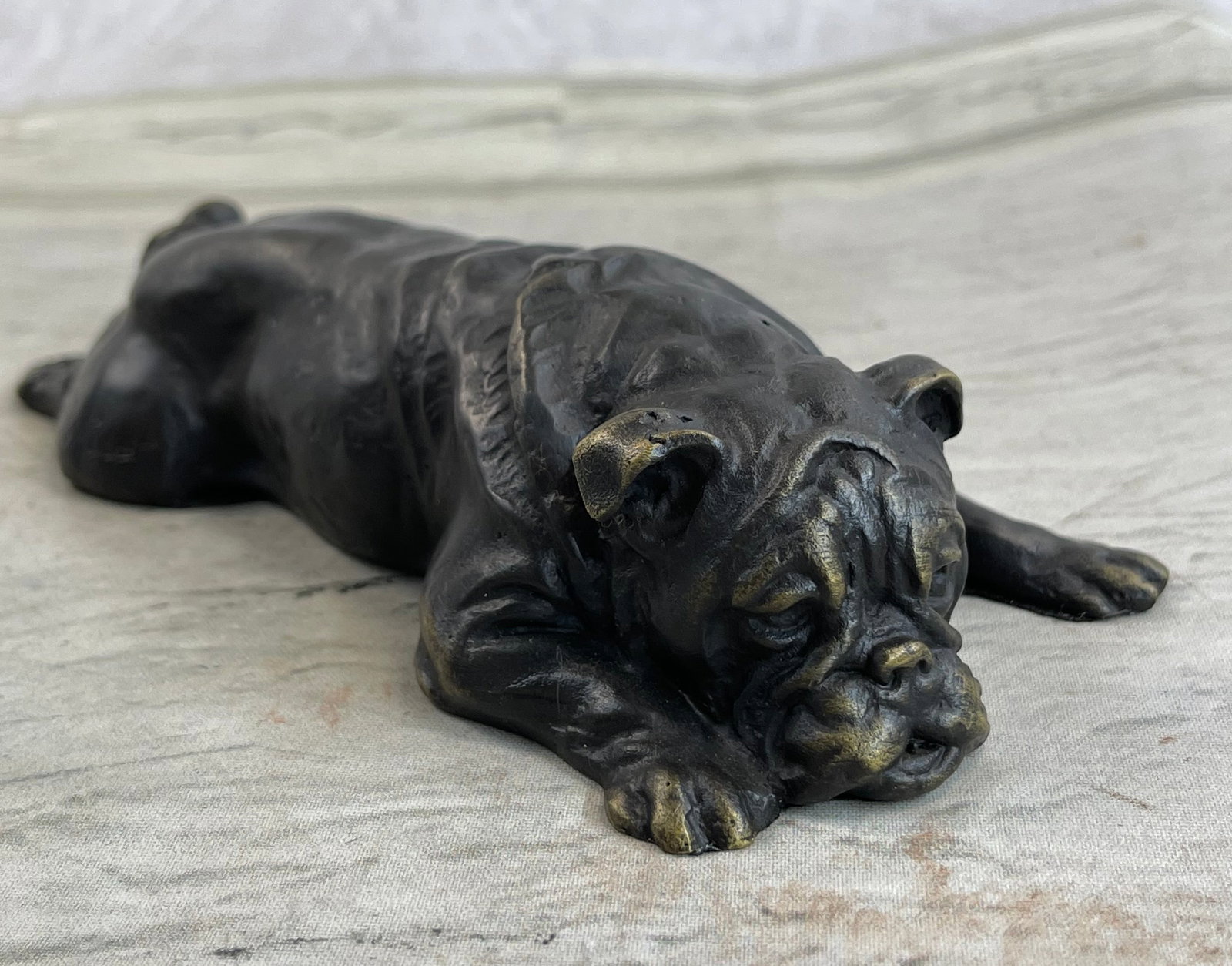 Sweet Little Bulldog Bronze Sculpture: This adorable Bronze Sculpture shows the sweetest little bulldog lying on his belly sprawled out on the marble. With the cutest and very lifelike facial features, this Bronze is sure to add a touch