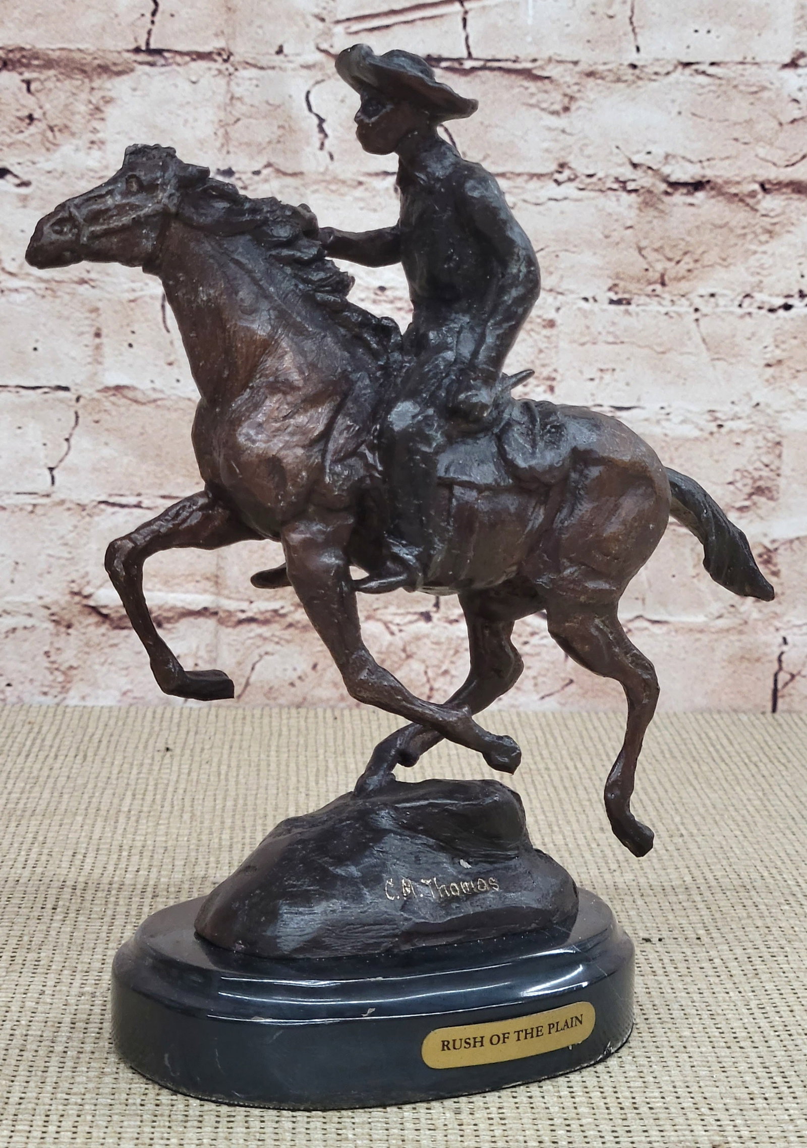 Man Riding Horse Bronze Figurine: A seasoned trooper cowboy is casually patrolling the area. He and his loyal horse gallop through the open dry plains. He is dressed in a shirt, chaps, and boots, giving him the look of a good ole fash