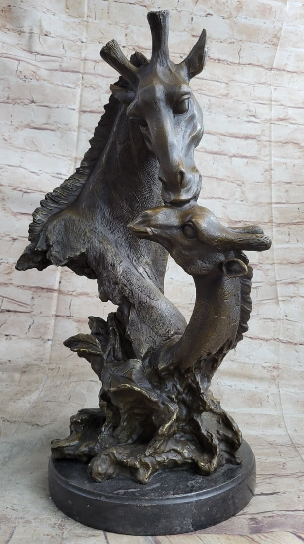 African Giraffe With Cub Bust Bronze Sculpture: Originating from the African continent, the giraffe is the tallest of all land-living animal species. Their scientific name is Giraffa camelopardalis, which is similar to its antiquated English name o