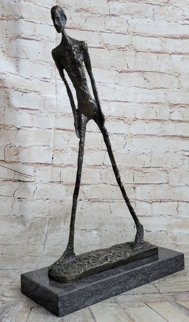 Modern Stuck Big Man Walking Bronze Statue: The handmade bronze sculpture was molded using the archaic method of lost wax casting and stained with a brown patina finish for perpetuation and it is mounted upon a marble base. Dimensions: Height 1
