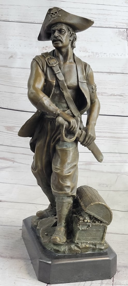 Pirate With Jewelry Chest and Sword Bronze Statue: This pirate stands with a sword ready in a swaggering pose, one hand on the sword hilt, one on the hip, and one foot resting on a coil of rope. A box full of jewelry is tucked next to him, and he is r