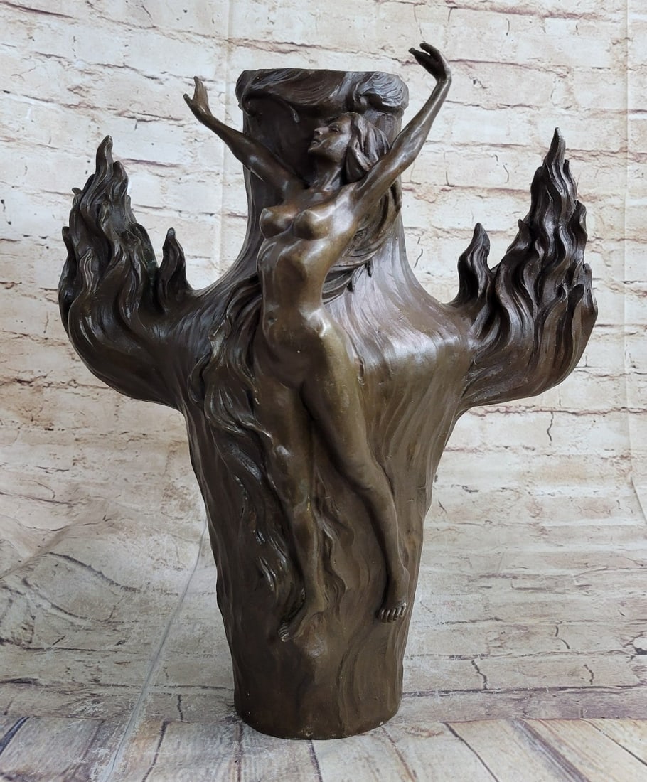 Exquisite Nude Vase Bronze Sculpture: An exquisite vase that would be the center of attention in any room. A nude nymph surrounds the vase. The nymph seems to grow like blossoming flowers. Vines and flowers creep around her, almost a part