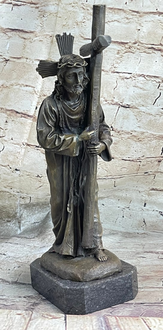 Jesus Christ Stations of the Cross Bronze Sculpture: Weary, Jesus Christ perseveres while forced to carry the cross to Calvary, where He was to be crucified. The large cross weighs down heavy on His shoulder and arms. The crown of thorns, meant to mock