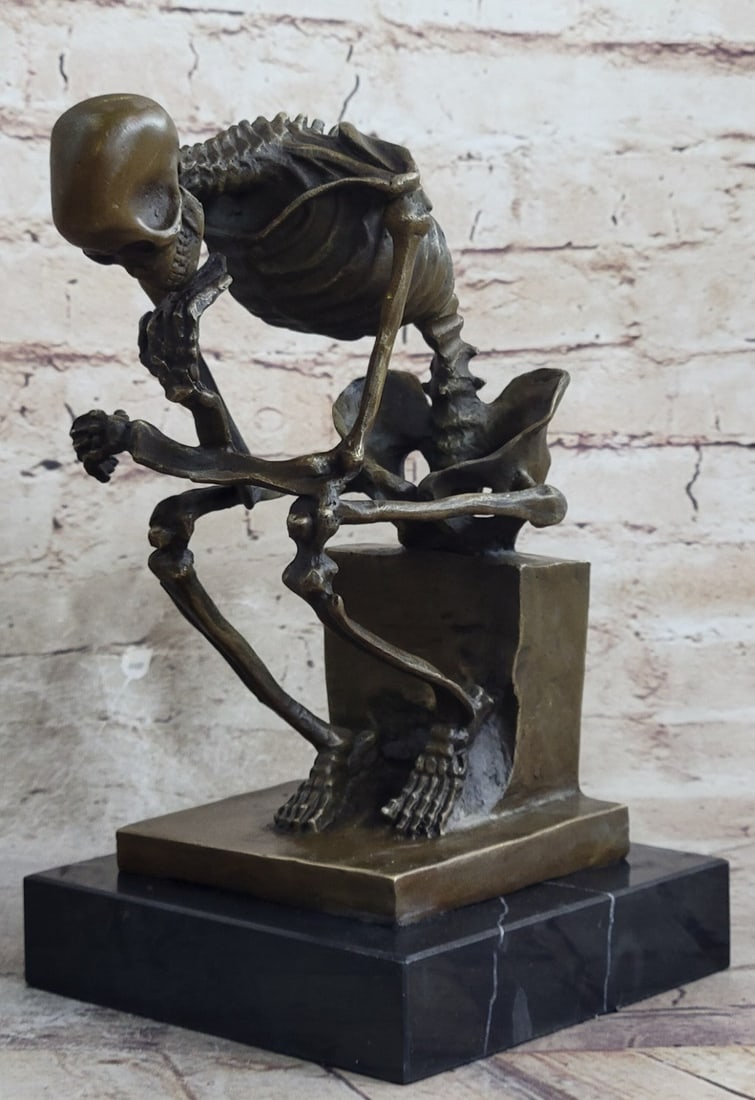Skeleton thinker Bronze Sculpture: The unique pose with hand to the chin, right elbow to the left knee, and crouching position allow the statue to survey the work with a contemplative feel. A Sculpture for fellow deep thinkers and a