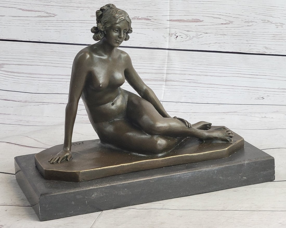 Victorian Lady Bronze Statue: Sitting provocatively yet elegantly, a confident young woman reveals her long curvy legs and is fully nude to stir envy amongst other women and to provoke lust amongst men who indulge her beauty. A fi