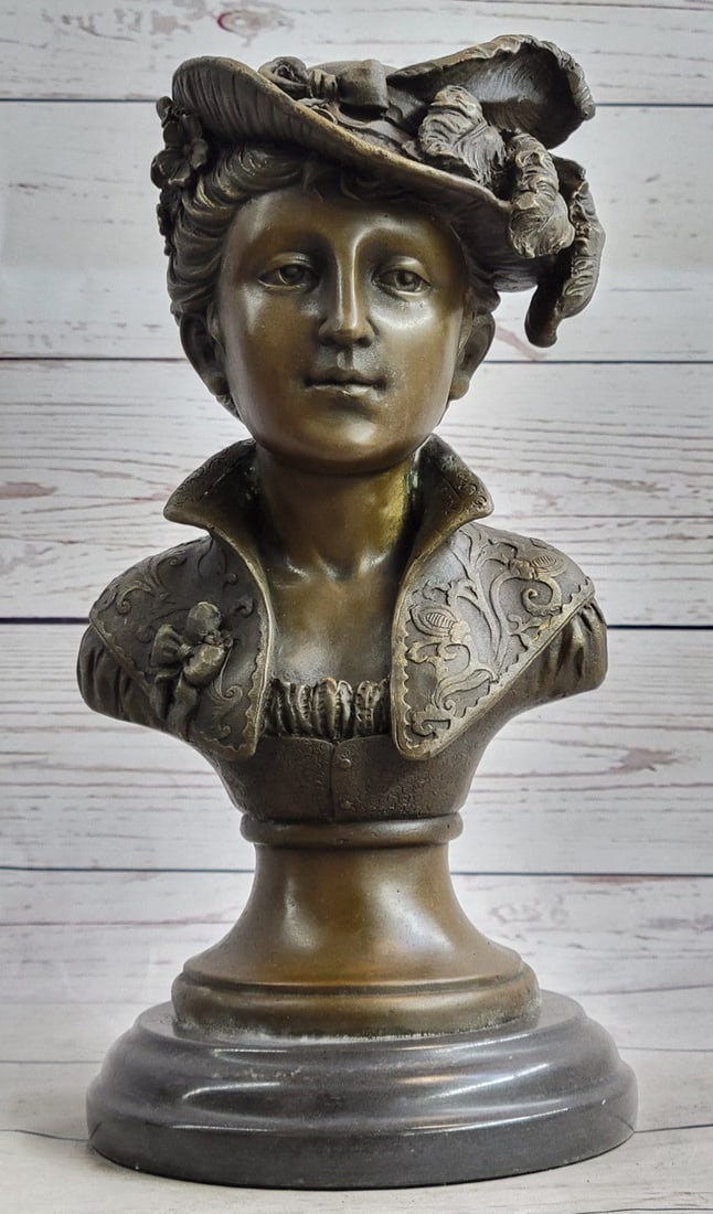 Female Bust Bronze Sculpture: A chic European woman is dressed to impress. She naturally radiates elegance in her daily life. A wonderful headdress adorns her head and is shifted off to the side of her face. This Bronze bust Sculp
