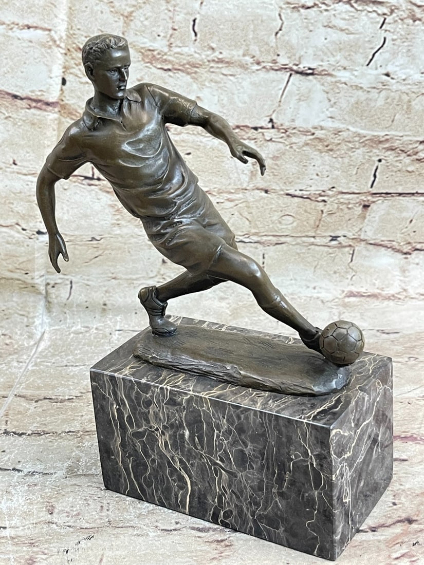 Soccer Player Bronze Figurine: He is a legend on the field. This soccer player tumbles down the grassy field, kicking, and dodging along the way. He is swift on his feet. He nears the goalpost and lunges one leg forward, propelling