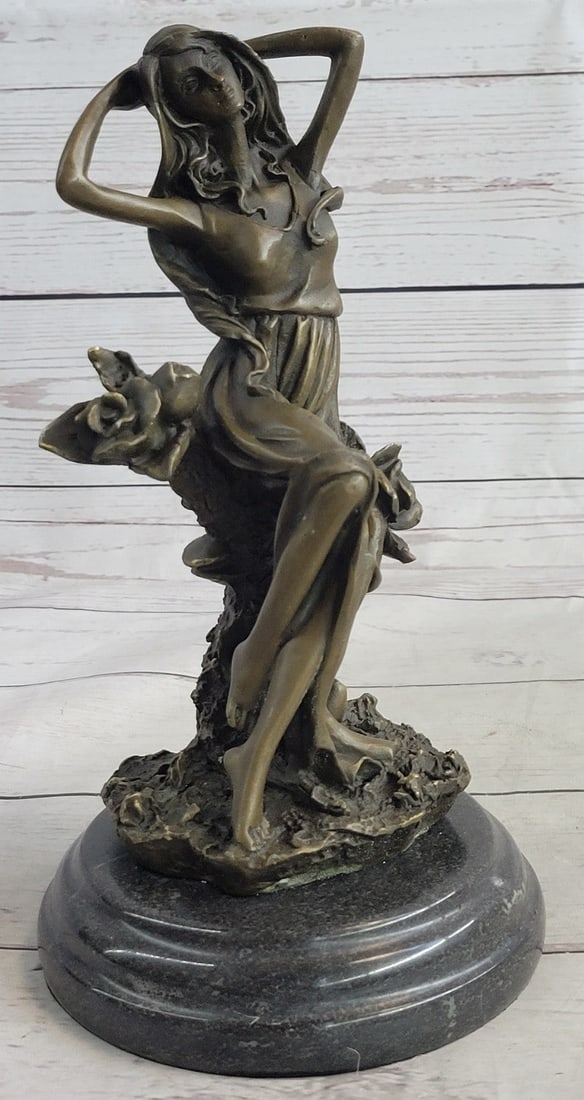 Sexy Lady Bronze Sculpture: This beautiful woman sits in the midst of a gorgeous flower garden and picked a bunch of different once for her home. She has this amazing long yet sexy dress, that reveals her legs. The beauty sits l