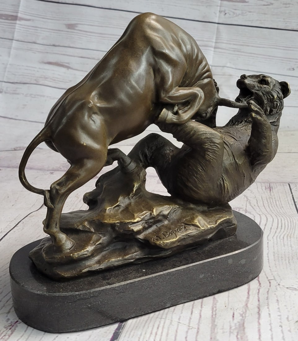 Wall Street - Bull vs. Bear Bronze Statue: A fierce battle has broken out between two known killers. The bull charges its horns in and the bear locks his massive paws over its head, pulling him into his plump body. The bear snarl sand roars. T