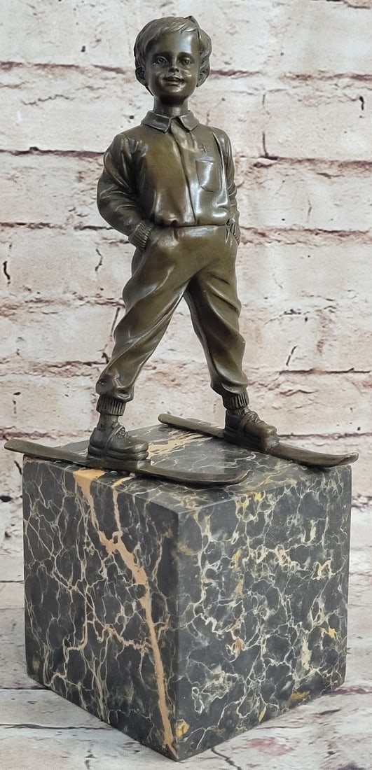 Sport Ski Player Bronze Statue: He learned to ski before he learned to ride a bike. This young cocky skier takes to the slopes freestyle. He tucks his hands into his pockets for warmth and casually drifts. He curves his skis outward