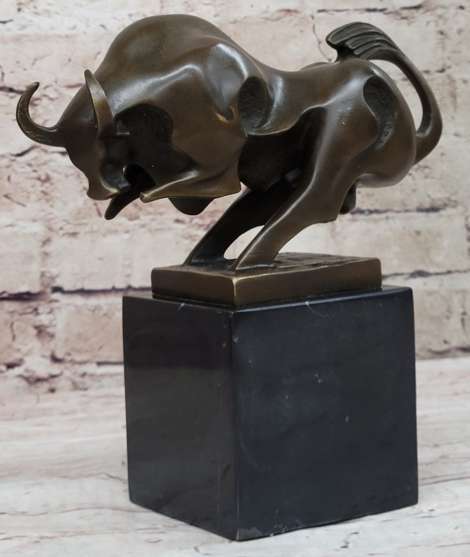 Charging Bull Bronze Sculpture: This magnificent modern and abstract sculpture is of a charging bull. With his head down, his nostrils\'92 flared and his muscles tightened he rears up to stomp the ground before him, releasing a vibr