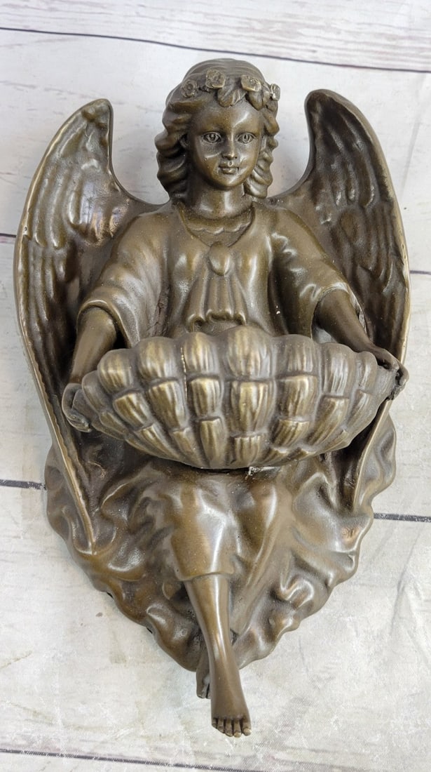 Young Guardian Angel Wall Mount Bronze Statue: A young Guardian Angel is the focal point of this fascinating wall mount sculpture. His kegs curve and transform into a heart-shaped, creating the place for your dreams. The boy sits with a cloth cove