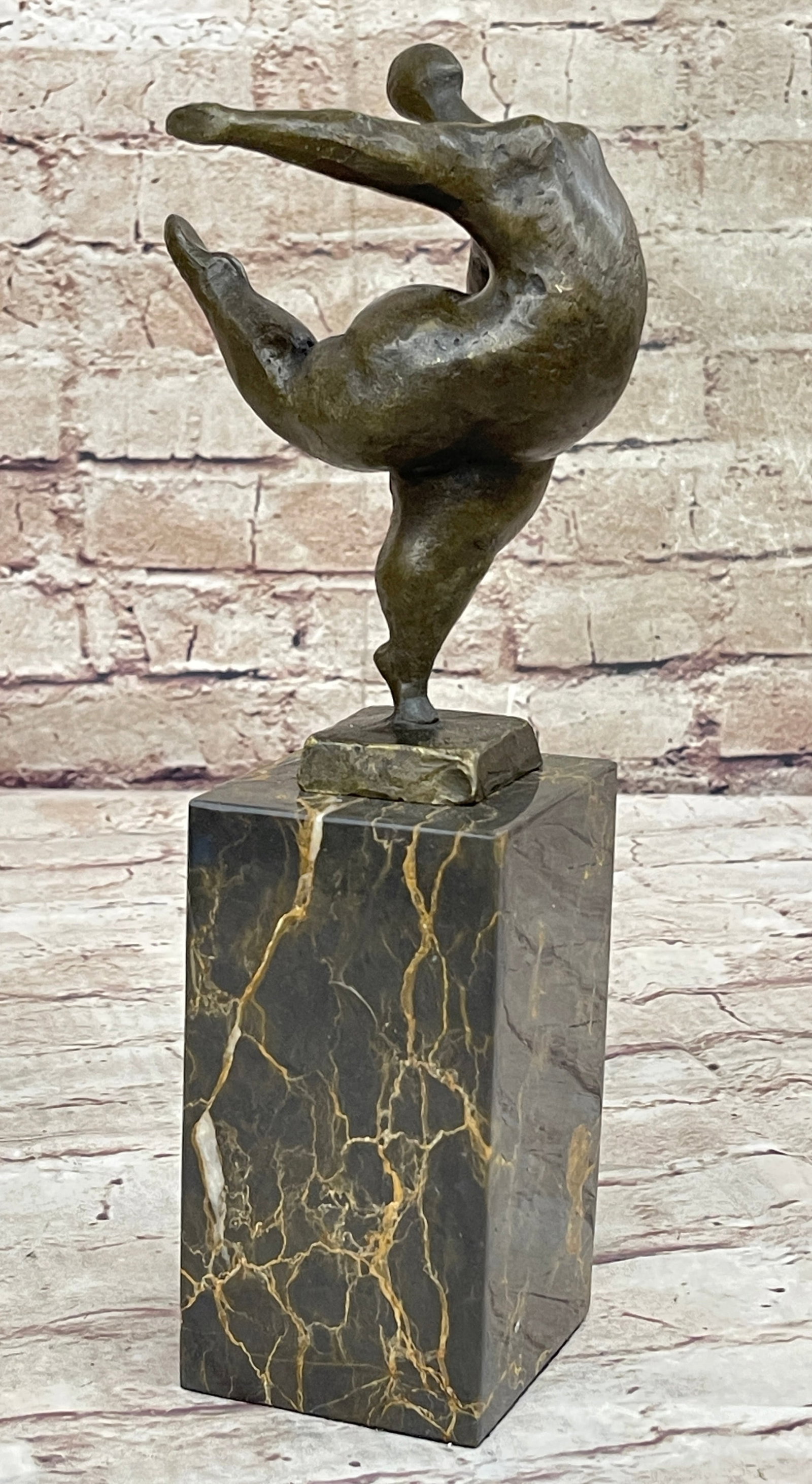 Abstract Bronze Sculpture: She is more than a dancer. She is an exhibitionist. An abstract woman puts on an eye-catching show. She dances in the nude provocatively. She balances on the tips of her toes, showing off her long rou