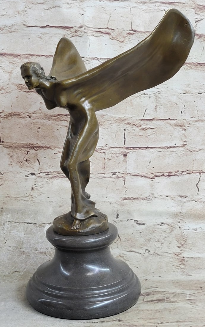 Mascot Spirit of Fabulous Rolls Royce Bronze Statue: The Bronze slender woman bends in a high bow. Both arms stretch backward birdlike as the definition of her limbs dissolves into wings of fabric. Her head is posed straight at the beholder as her eyes