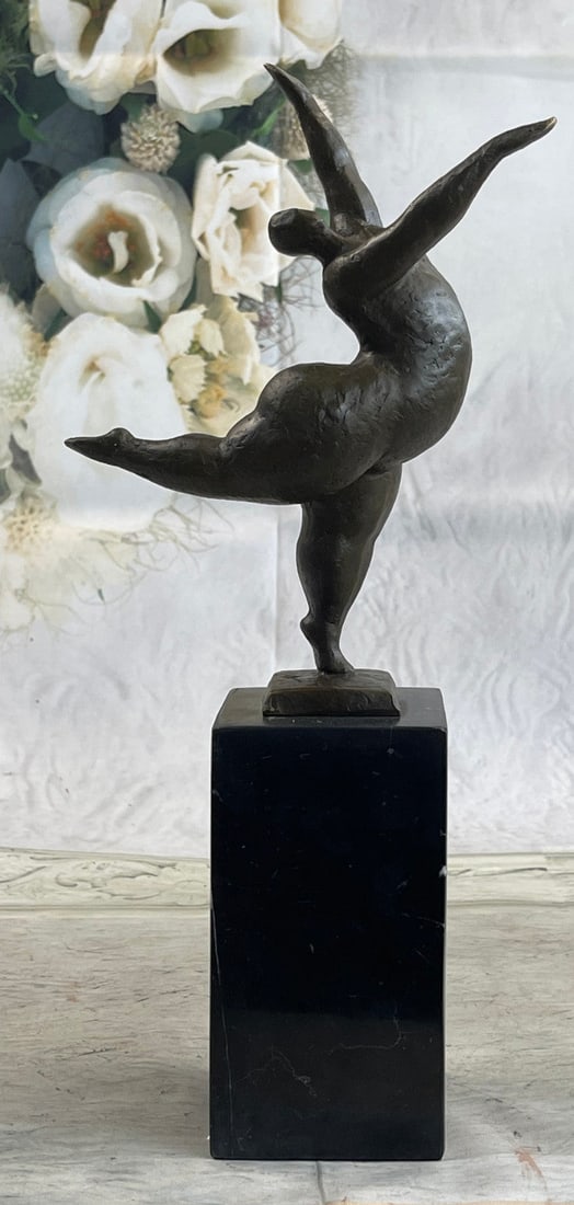 Ballerina Bronze Figurine: She is more than a dancer. She is an exhibitionist. An abstract woman puts on an eye-catching show. She dances in the nude provocatively. She balances on the tips of her toes, showing off her long