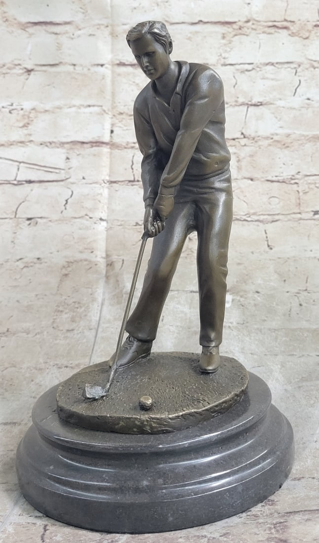 Sports Memorabilia Golf Club Bronze Figure: A golfer tilts her head up to the sun and watches her ball rise. She holds her form and stance, tracking the position of the ball and how close to the green it may land. Her body twists with her strok