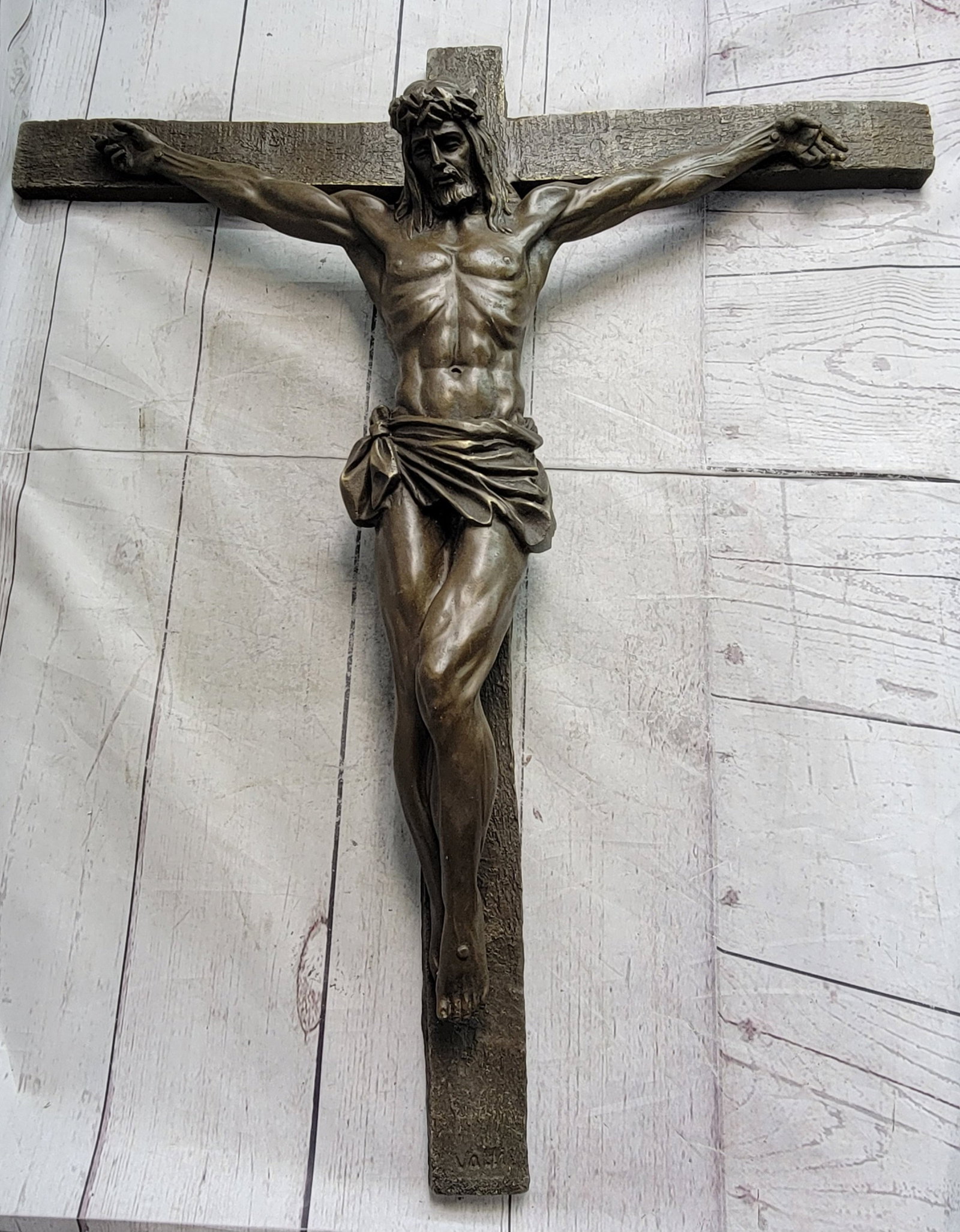 Jesus Crucifixion Bronze Sculpture: Christ, hanging below a sign proclaiming INRI, or King of the Jews, is depicted on the cross where he gave his life as restitution for all who believe, repent and call on His name. This artist symbol 