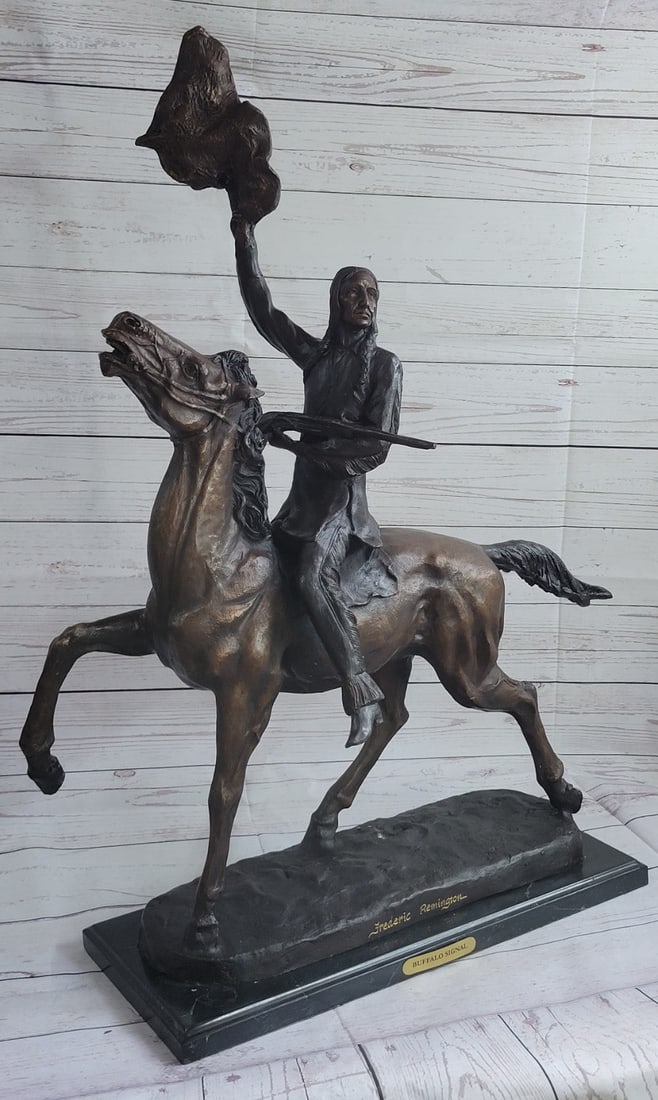 Buffalo Signal Native American on Horse Bronze Sculpture: The Buffalo Signal captures a Native American warrior who sits triumphantly atop his horse. He holds his head high with defiance and triumph set in his intense eyes. Above his head, he holds the hide 