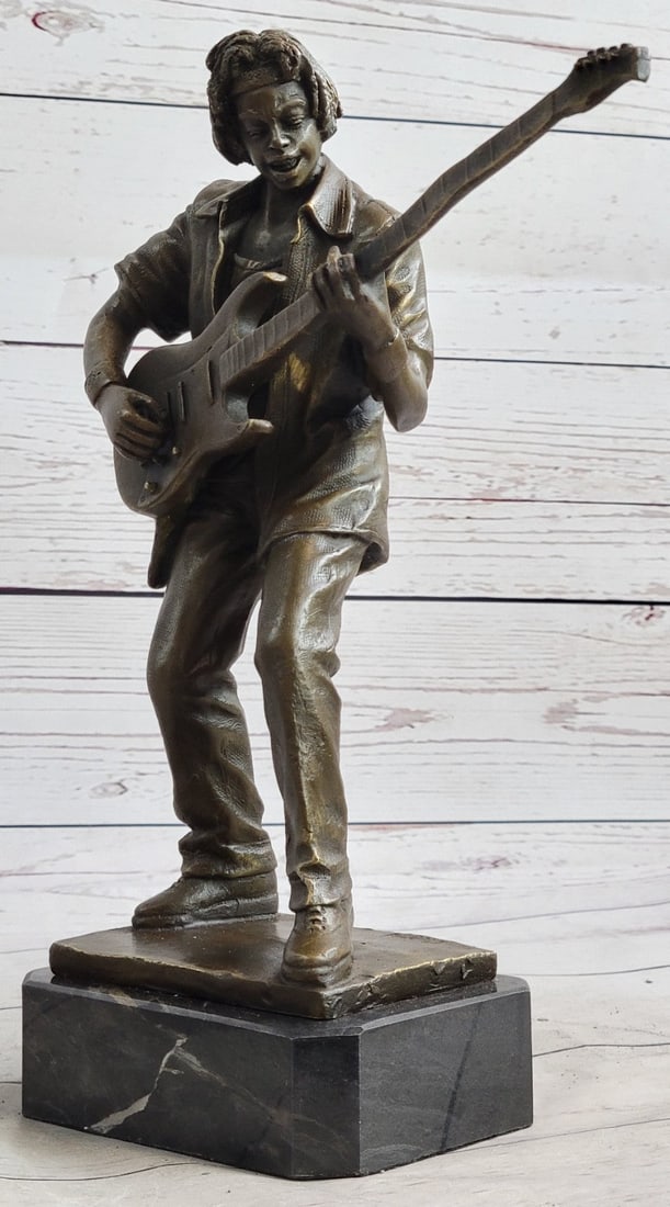 Guitar Player Bronze Sculpture: This amazing and creative abstract of Rick James playing his Guitar is exquisite. He is made with the creation of your imagination. His eyes are concentrating on each string he touches, making sure he