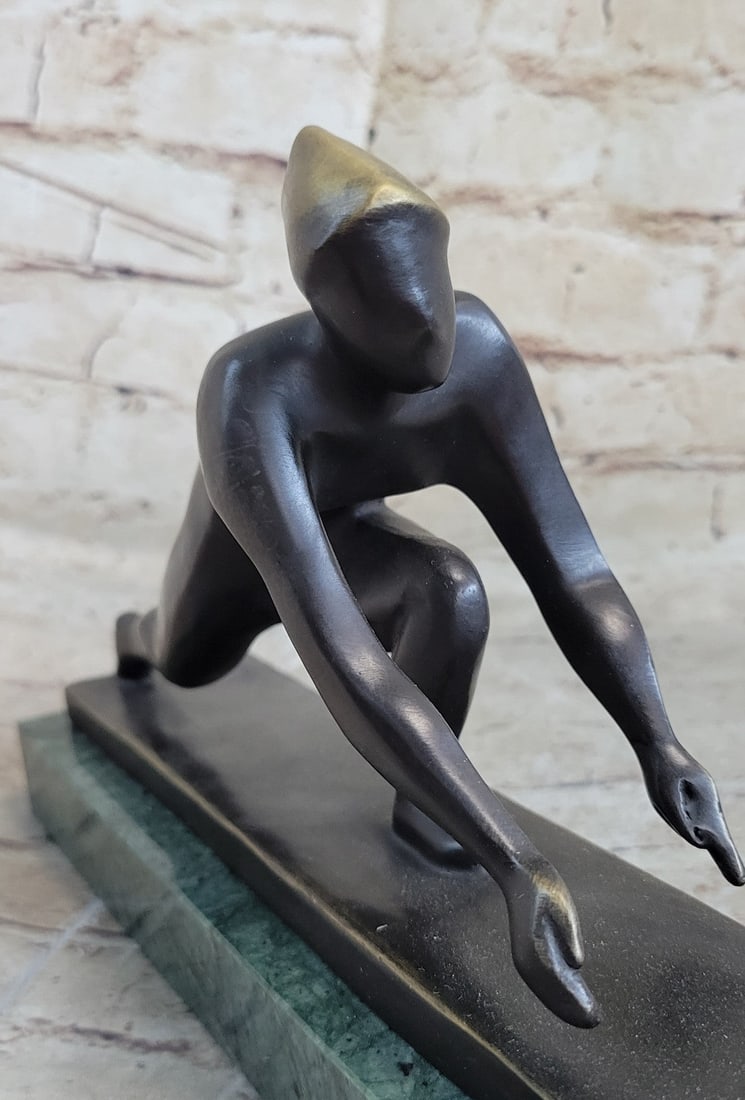 Curling Bronze Sculpture: A powerful Bronze Sculpture, an interpretation of a man curling on Ice. The beautifully rendered features wearing a helmet, mouth set in determination, muscles straining against the elements of nature