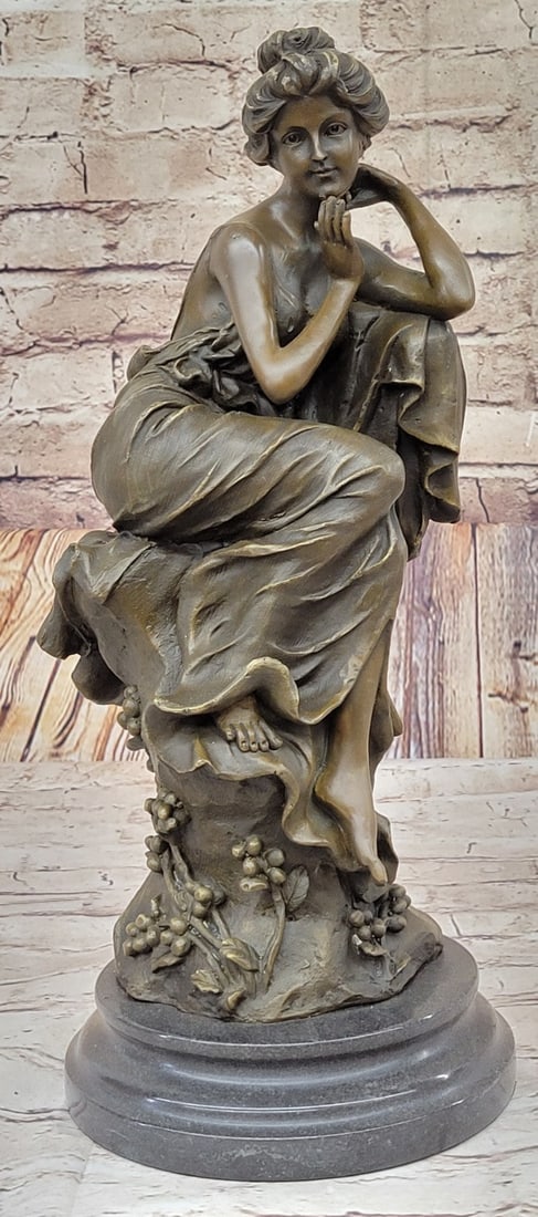 Female Bronze Statue: This Gorgeous Sculpture Of A Woman Posing For The Camera Is Astonishing. She Sits Back On A Pillar Of Some Sort And Lets Her Body Do The Talking. She Looks Amazing As She Stay Still With Her left