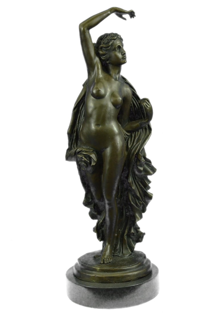 Erotic Female Bronze Sculpture: The bronze beauty daintily walks forward gracefully letting her thick robe slide down the contours of her body to the floor. Her right-hand hangs suspended in the air having just dropped that fabric